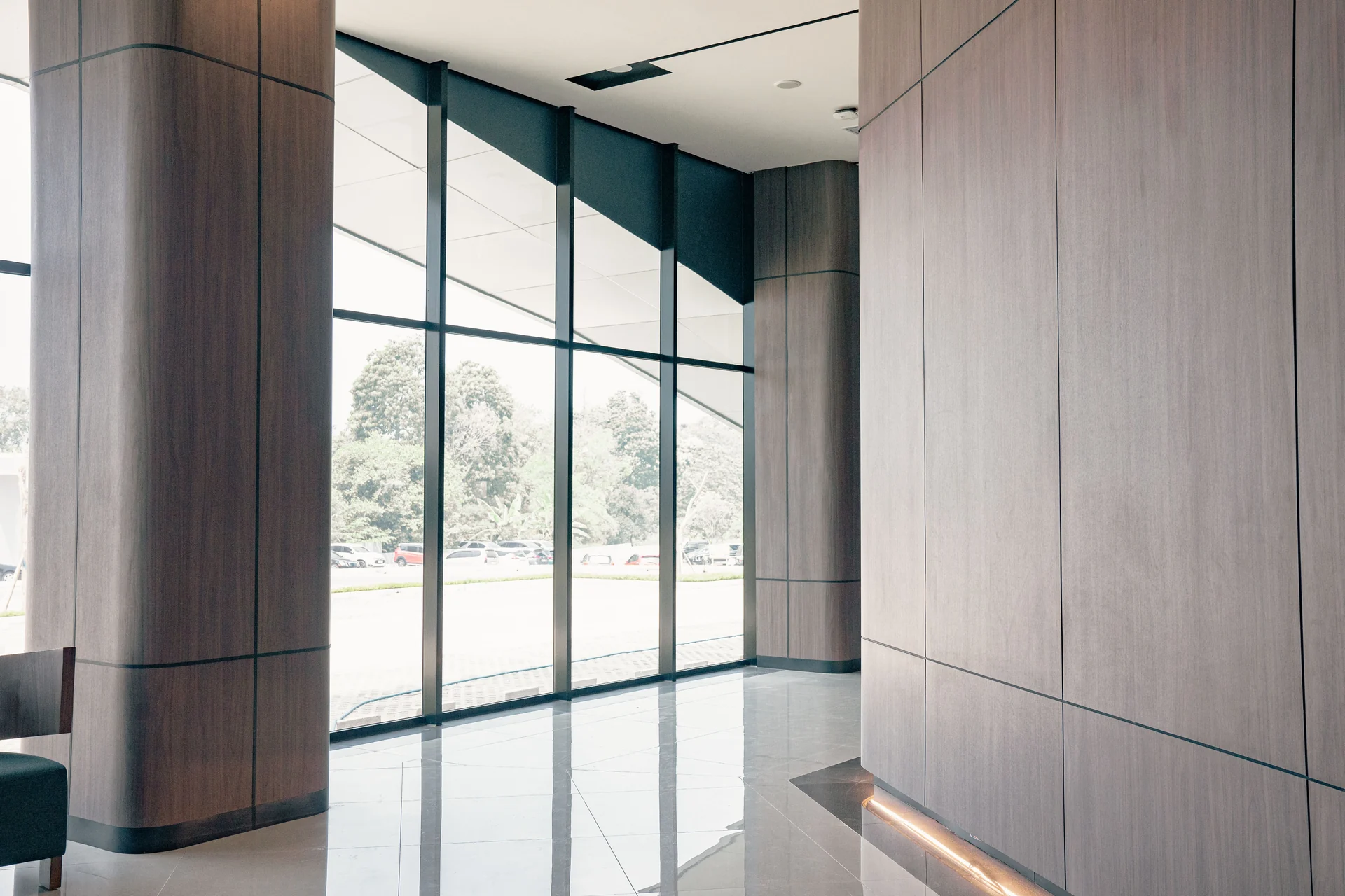 Modern commercial lobby with glass walls and polished stone floors